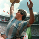 Maradona holds up World Cup trophy in 1986.